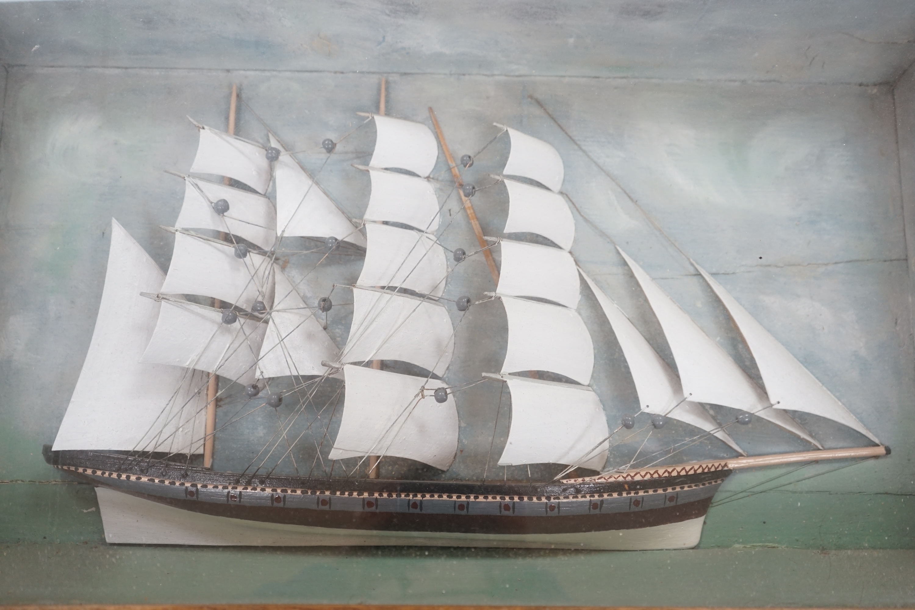 An early 20th century diorama of a ship in full sail, 70cm wide. Condition - fair